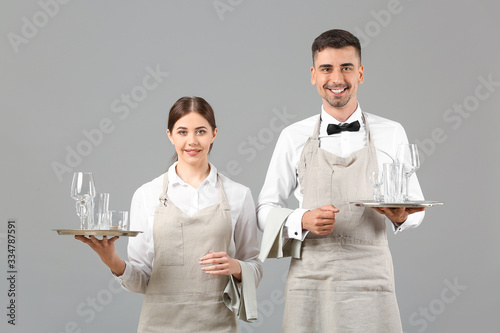 Portrait of waiters on grey...