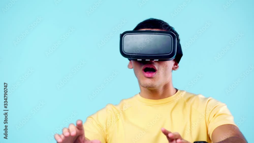 excited man gesturing while using vr headset isolated on blue excited man gesturing while using vr headset isolated on blue