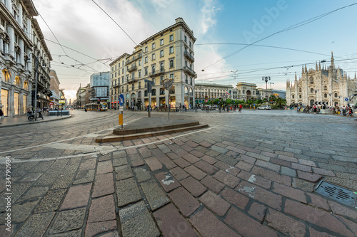 MILAN, ITALY - AUGUST 1, 2019 : The piazza, looking roughly north-east to the Duomo - on the right, and the arch that marks the entrance to Galleria Vittorio Emanuele II - on the left