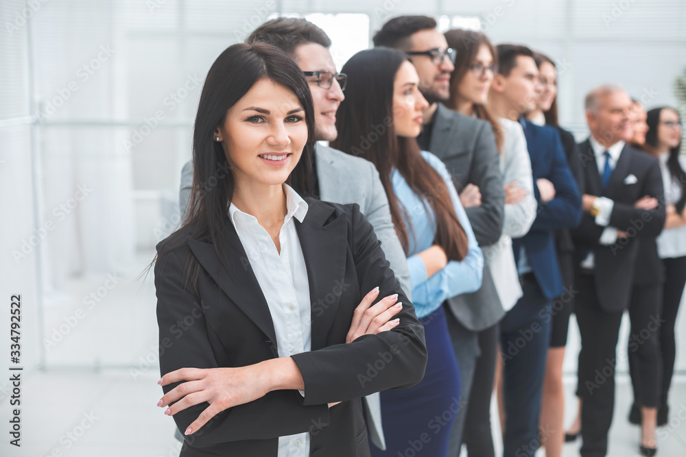 young business woman standing in front of her colleagues young business woman standing in front of her colleagues