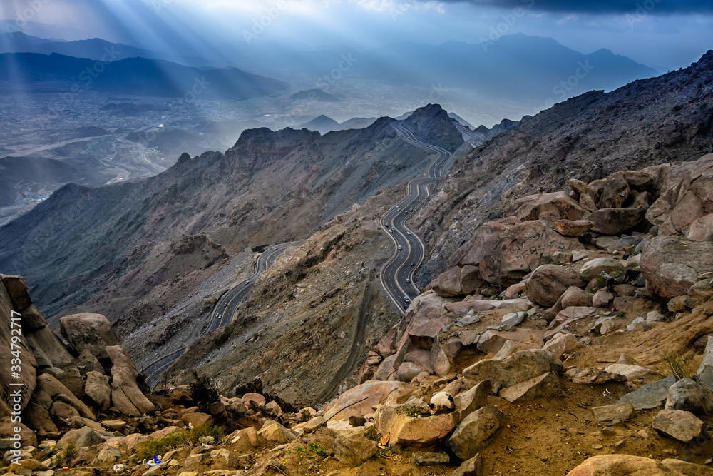 Long exposure of car light trails on a foggy mountain road at Al Huda, Saudi Arabia