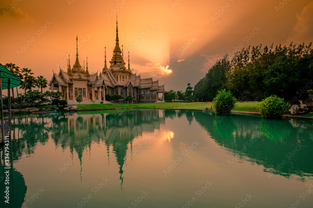 Fototapeta premium Wallpaper Wat Lan Boon Mahawihan Somdet Phra Buddhacharn(Wat Non Kum)is the beauty of the church that reflects the surface of the water, popular tourists come to make merit and take a public photo