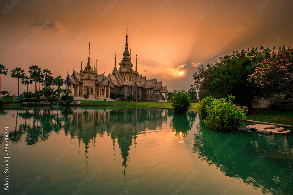 Fototapeta premium Wallpaper Wat Lan Boon Mahawihan Somdet Phra Buddhacharn(Wat Non Kum)is the beauty of the church that reflects the surface of the water, popular tourists come to make merit and take a public photo