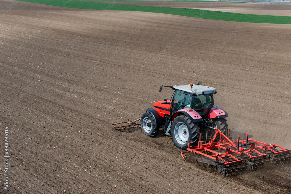 Fototapeta premium Tractor working in the field