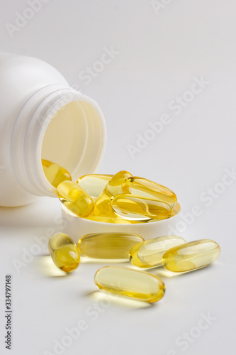 fish oil pills and bottle isolated on white background