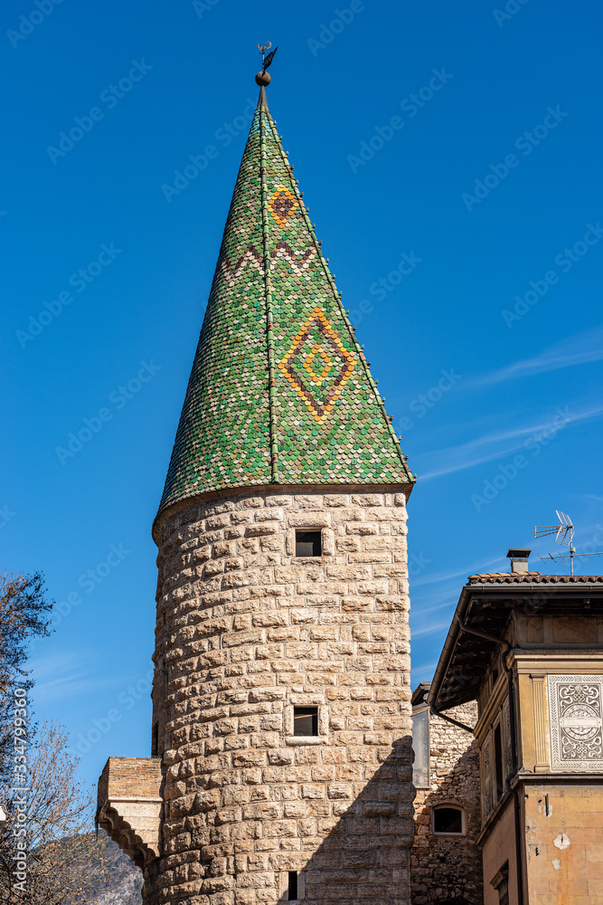 Torre Verde (Green tower), medieval watchtower in Trento downtown, with green majolica roof tiles and ashlar stone wall. Trentino-Alto Adige, Italy, Europe