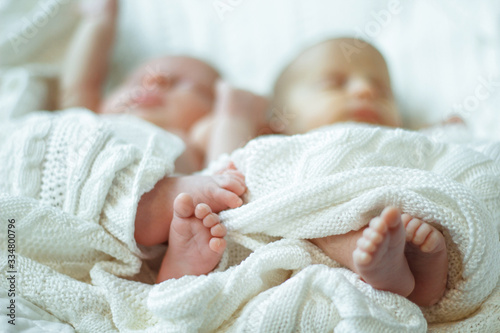 Photos baby legs closeup wrapped in a white blanket blurred background