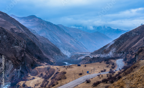 Mountain landscape with a road and low clouds