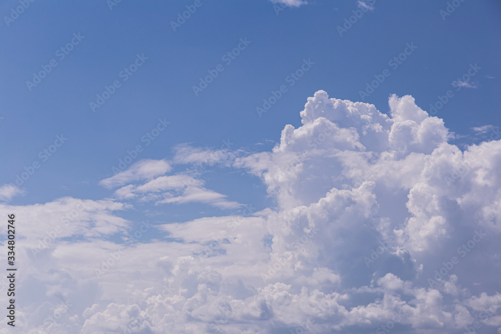 Fototapeta premium Blue sky background with white clouds on sunny day.