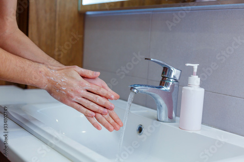 Fototapeta Naklejka Na Ścianę i Meble -  man washes his hands at home