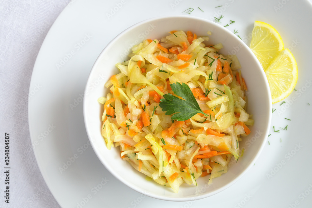 cabbage carrot and dill salad dressed with oil and decorated with parsley leaf cabbage carrot and dill salad dressed with oil and decorated with parsley leaf