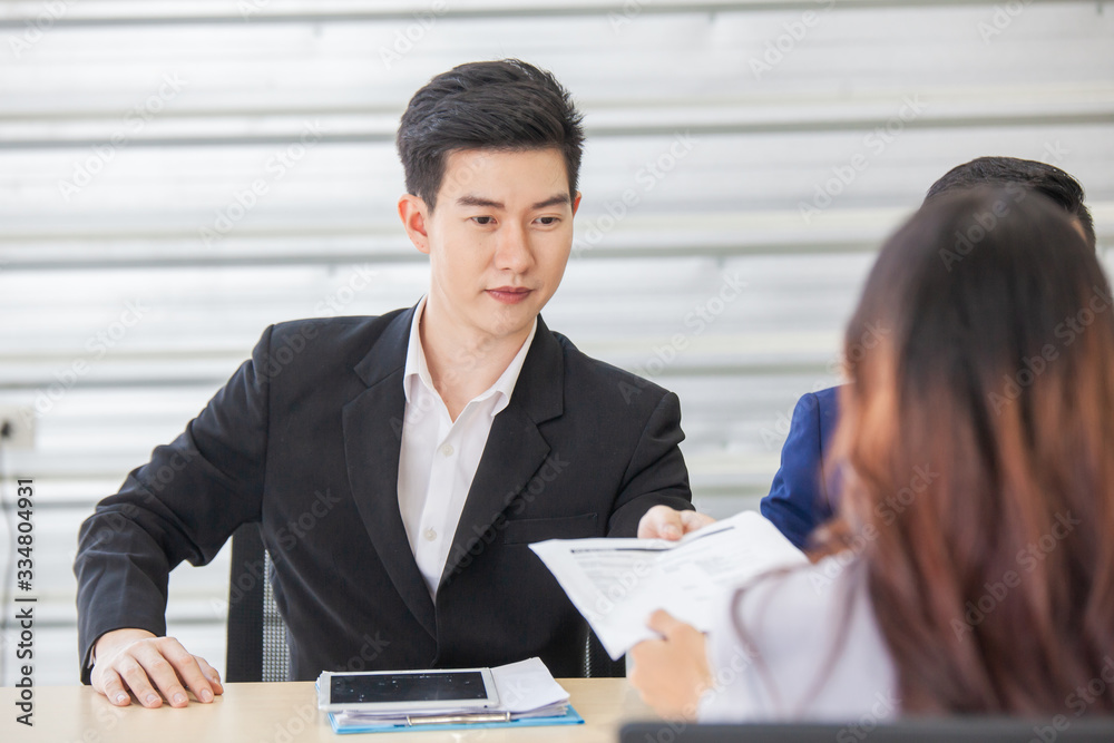 Business manager give papers presenting document report business plan to team people at corporate meeting Business manager give papers presenting document report business plan to team people at corporate meeting