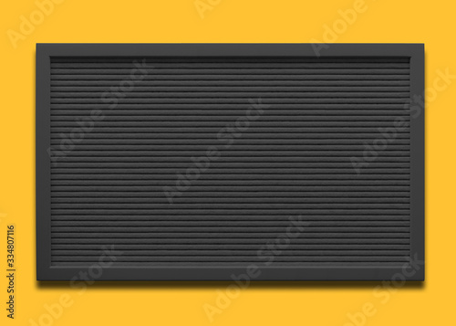 Empty black message board on the yellow background 