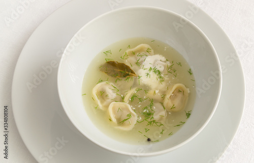 dumplings in broth with dill and sour cream