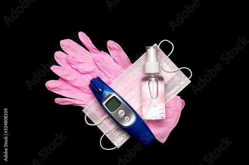 Medical gloves surgical mask, sanitizer gel, modern thermometer - Virus protection equipment on black background. China pathogen respiratory coronavirus 2019-ncov flu outbreak medical concept photo