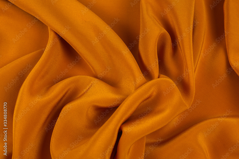 Golden silk or satin luxury fabric texture can use as abstract background. Golden silk or satin luxury fabric texture can use as abstract background.
