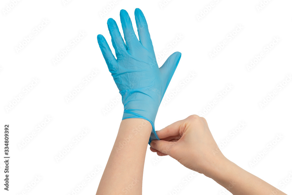 Woman puts on blue rubber gloves.