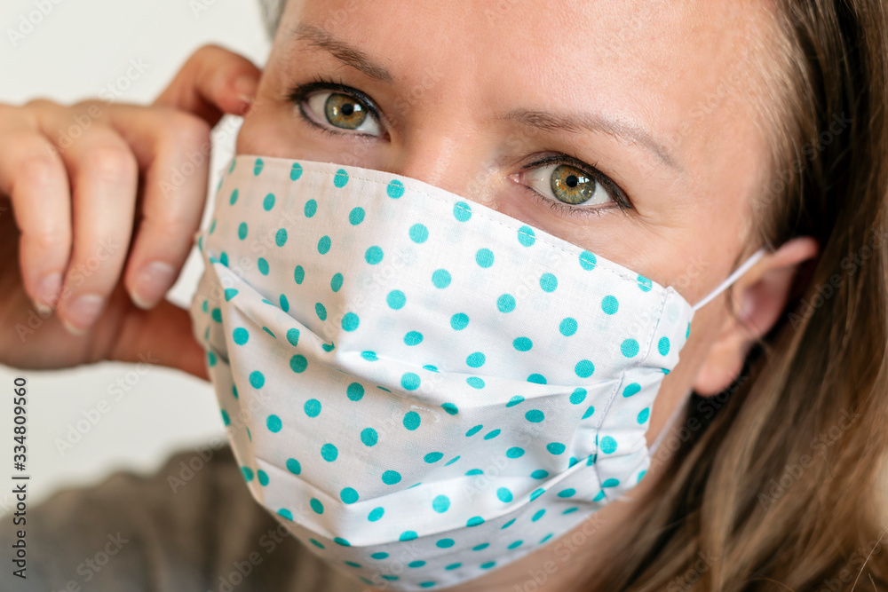 Portrait of woman wearing handmade cotton fabric face mask. Protection against saliva, cough, dust, pollution, virus, bacteria, COVID-19. Portrait of woman wearing handmade cotton fabric face mask. Protection against saliva, cough, dust, pollution, virus, bacteria, COVID-19.