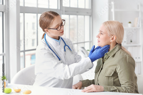 Doctor examining senior wom...