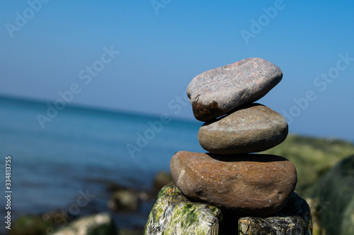 zen stones by the sea or ocean on a sunny day