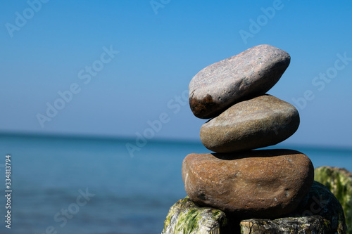 zen stones by the sea or ocean on a sunny day