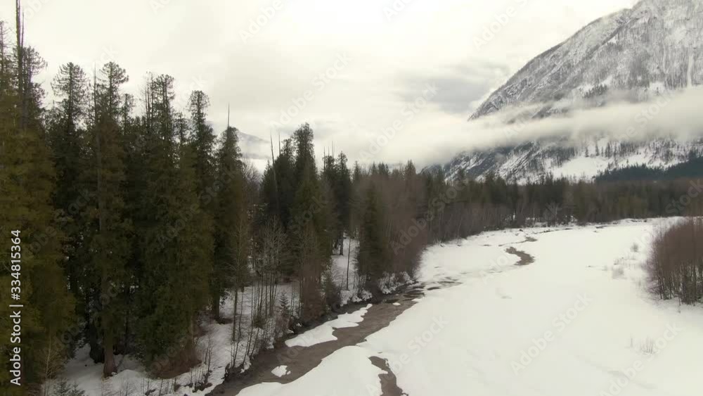 Aerial Drone View of a beautiful Snow Covered Valley and River in Canadian Mountain Landscape during a cloudy winter day. Taken near Pemberton, British Columbia, Canada. Aerial Drone View of a beautiful Snow Covered Valley and River in Canadian Mountain Landscape during a cloudy winter day. Taken near Pemberton, British Columbia, Canada.