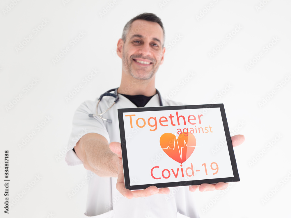 Handsome middle aged male doctor hands a message on his tablet : Handsome middle aged male doctor hands a message on his tablet :