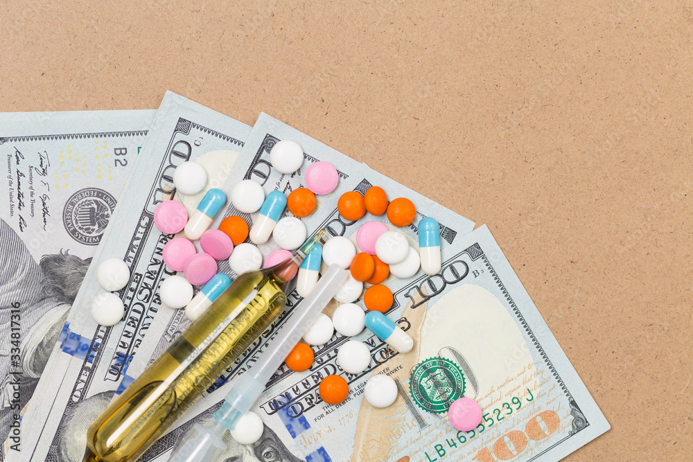 Assorted pharmaceutical medicine pills, tablets and capsules on US dollars. Healthcare concept. Crisis Money Free space Assorted pharmaceutical medicine pills, tablets and capsules on US dollars. Healthcare concept. Crisis Money Free space