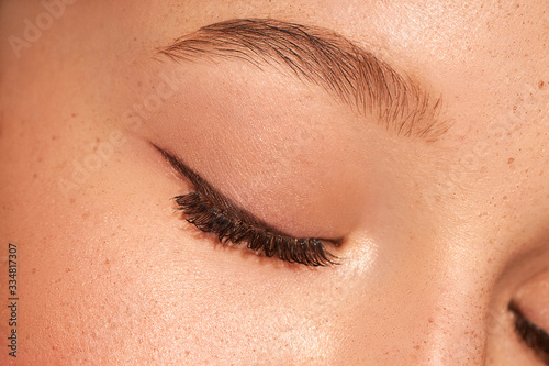 Close up of female clouse eye. Clean skin. Blue eyes.Natural retouching. Arrows on the eyes 