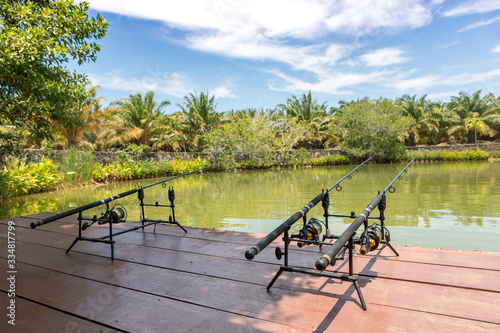 Fishing rod, spinning reel on the background of the lake. Lake for bottom fishing.