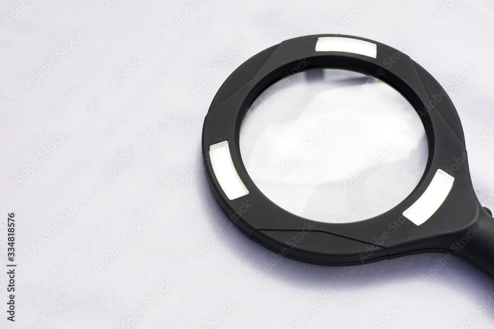 Close up view of a black medical laboratory magnifying glass, isolated on white background. Close up view of a black medical laboratory magnifying glass, isolated on white background.