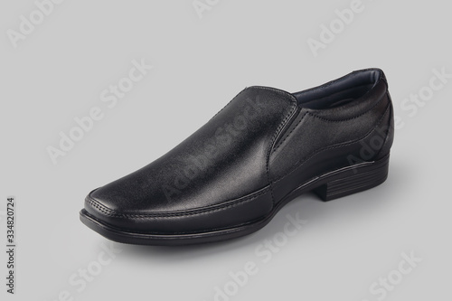 Black leather elegant shoes on gray background