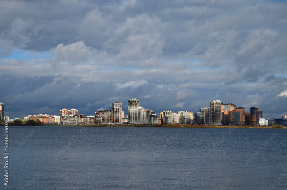 river and clouds on the horizon of the city's tall buildings