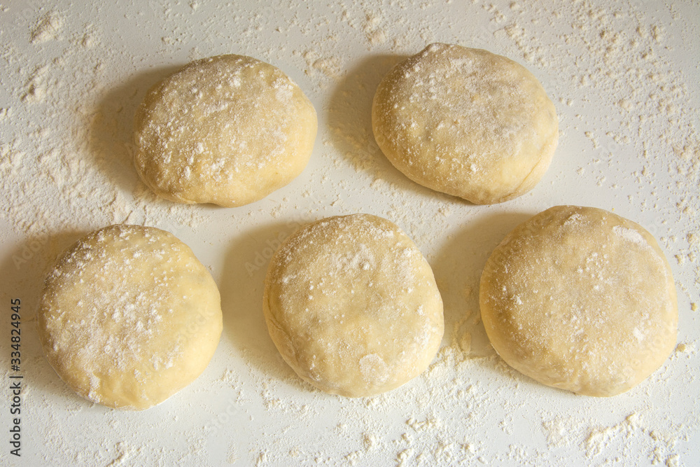 Traditional russian patties made of raw dough with onion and rise filling prepared for baking Traditional russian patties made of raw dough with onion and rise filling prepared for baking