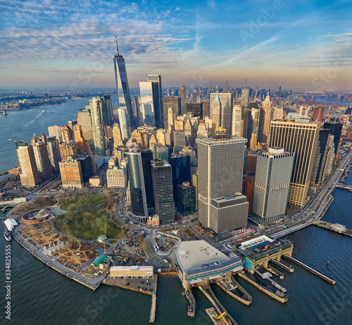 Aerial view of the Manhattan business district with modern office towers and battery park during golden hour 