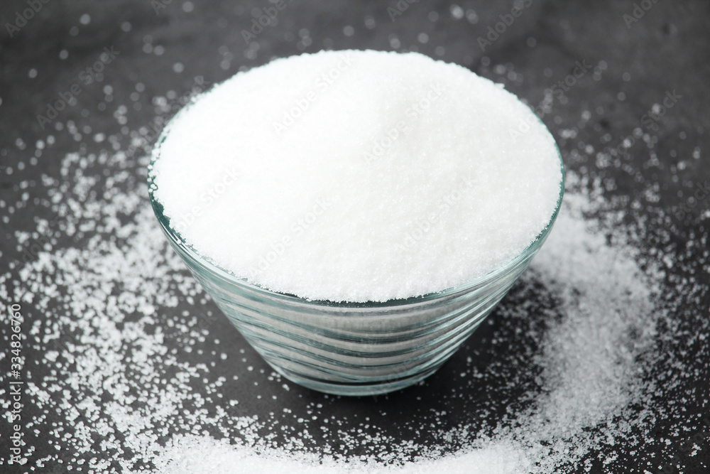 A glass bowl with white sugar A glass bowl with white sugar