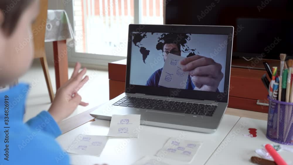 Child studying homework math during his online lesson at home, social distance during quarantine. Self-isolation and online education concept caused by coronavirus pandemia