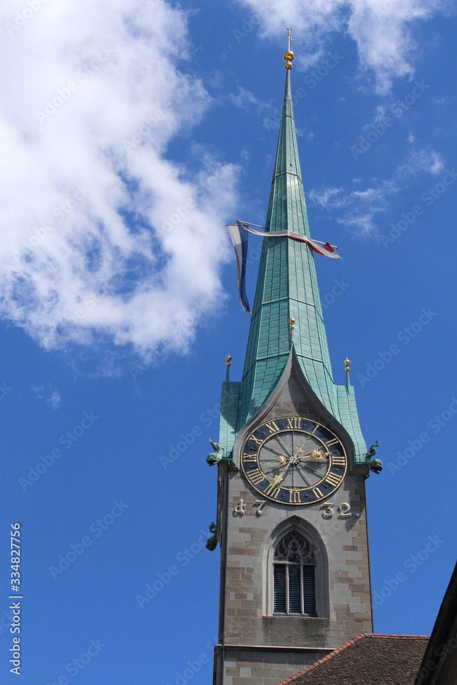 Old tower of Fraumuenster (Women's Minster) church with a clock at the city center of Zurich in Switzerland. Old tower of Fraumuenster (Women's Minster) church with a clock at the city center of Zurich in Switzerland.