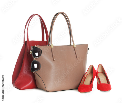 Different stylish woman's bags, shoes and sunglasses isolated on white