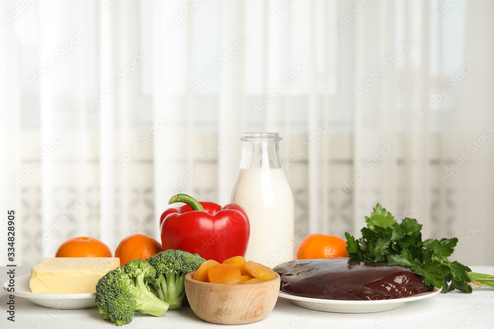 Fresh products rich in vitamin A on white wooden table Fresh products rich in vitamin A on white wooden table