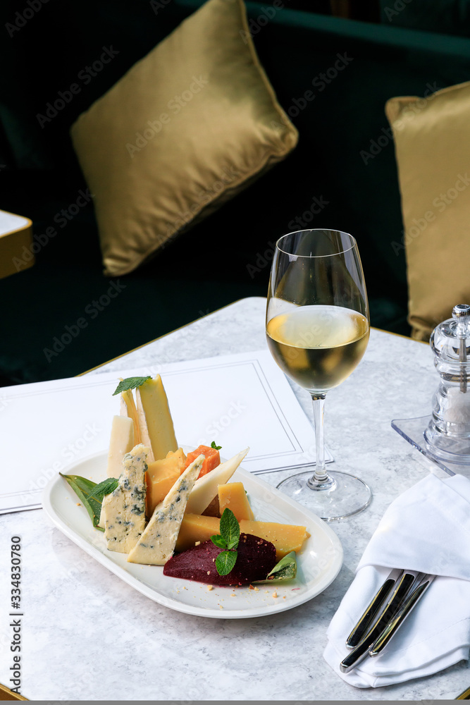 wine set. Assorted cheeses. brie, dor blue, frico, cheddar, picorino, ground pear with almonds. white wine. wine set. Assorted cheeses. brie, dor blue, frico, cheddar, picorino, ground pear with almonds. white wine.