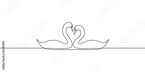 Couple of beautiful swans gliding on water surface in continuous line art drawing style. Birds in love. Minimal black linear sketch isolated on white background. Vector illustration
