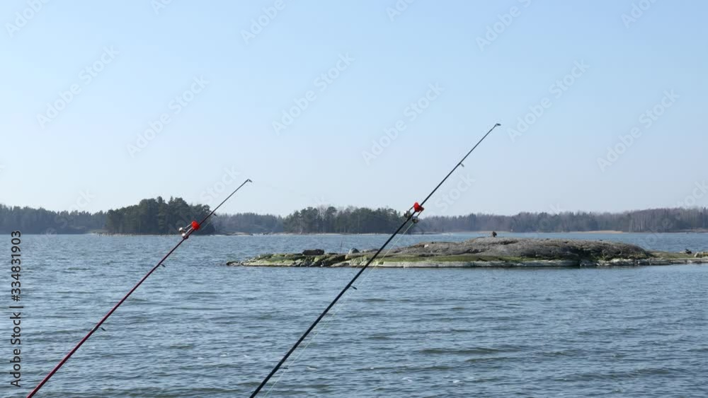 Two fishing rods waiting for the catch. Sea space. Calm sea, no people and ships. Two fishing rods waiting for the catch. Sea space. Calm sea, no people and ships.