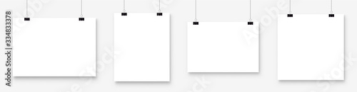 Photo White blank poster template hanging on wall