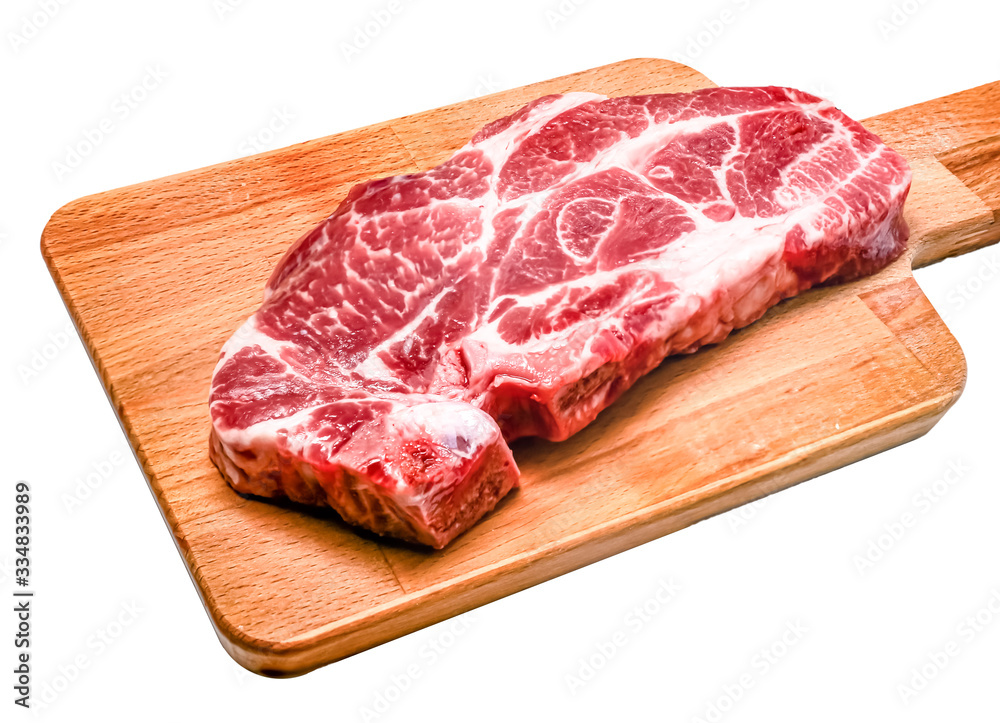 Raw steak from pork neck tender lies on a wooden Board on a white background. Isolated Raw steak from pork neck tender lies on a wooden Board on a white background. Isolated
