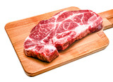 Raw steak from pork neck tender lies on a wooden Board on a white background. Isolated