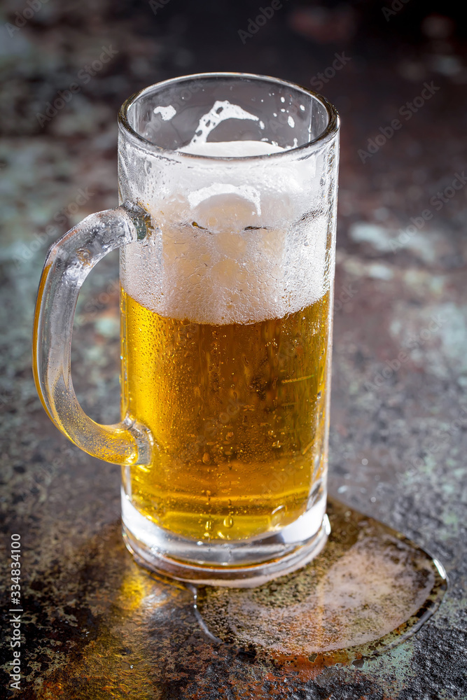 Light beer in a glass, on an old background. Light beer in a glass, on an old background.
