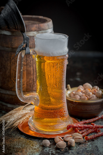 Light beer in a glass, on an old background.