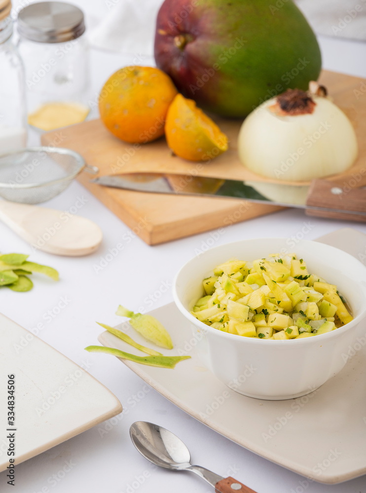 Mango ceviche in a white bowl with ingredients Mango ceviche in a white bowl with ingredients