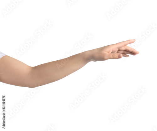 Woman pointing at something against white background, closeup on hand © New Africa